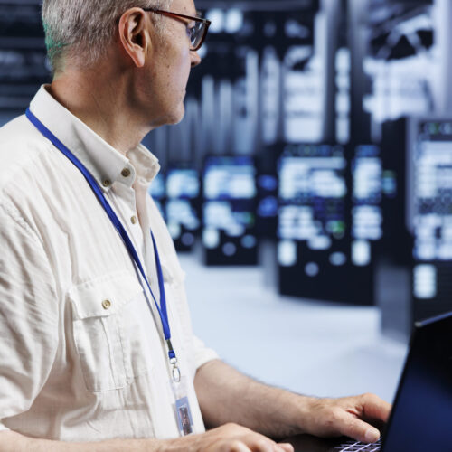 Certified professional uses laptop, setting up high bandwidth dedicated multiplayer gaming servers in cloud computing business to accommodate traffic from worldwide locations and avoid low ping rates