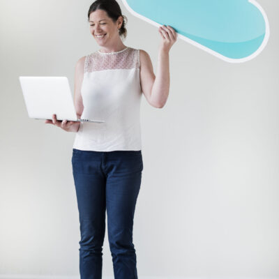 White woman using computer cloud network